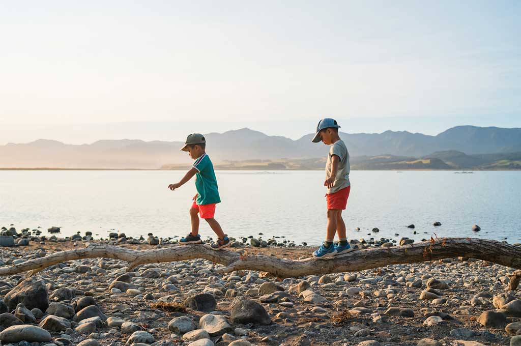 Children walking on the log trying to balance.